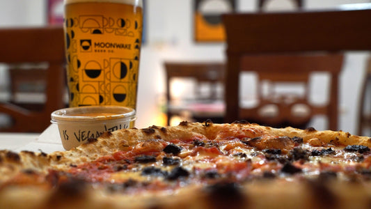 Fresh pint of beer and Pizza Geeks pizza at Moonwake taproom in Leith